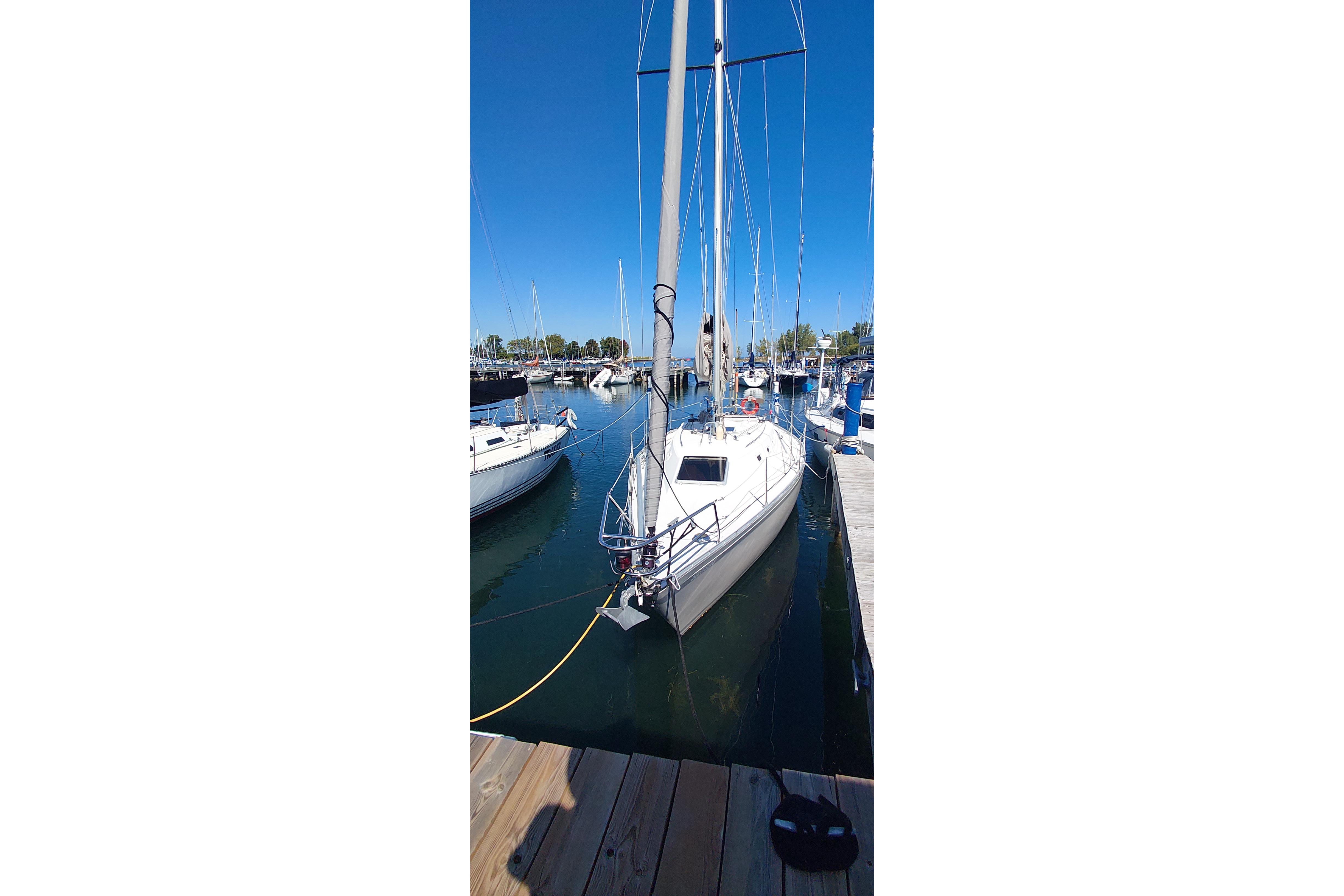 1983 CS 36 Traditional sailboat docked in a marina under clear blue skies.
