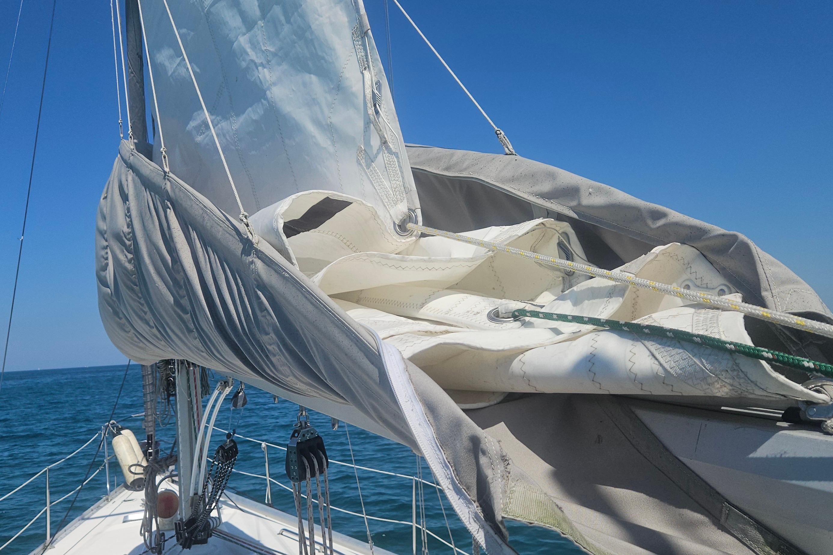 Sailboat CS 36 Traditional 1983 with sails furled, sailing on a clear blue sea.