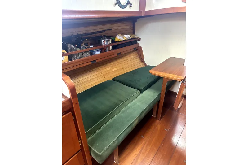 Solimar Yacht Photos Pics Interior of 2000 Sam L. Morse Bristol Channel Cutter 28 with green cushions and wooden table.