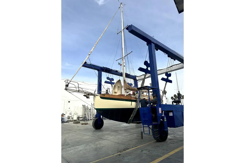 Solimar Yacht Photos Pics Sam L. Morse Bristol Channel Cutter 28, 2000, on a boat lift at a shipyard.
