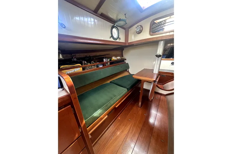 Solimar Yacht Photos Pics Interior of 2000 Sam L. Morse Bristol Channel Cutter 28 with green cushioned seating.