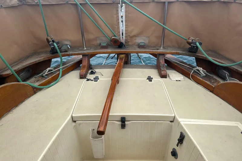 Solimar Yacht Photos Pics Cockpit of 2000 Sam L. Morse Bristol Channel Cutter 28 sailboat with wooden tiller and ropes.