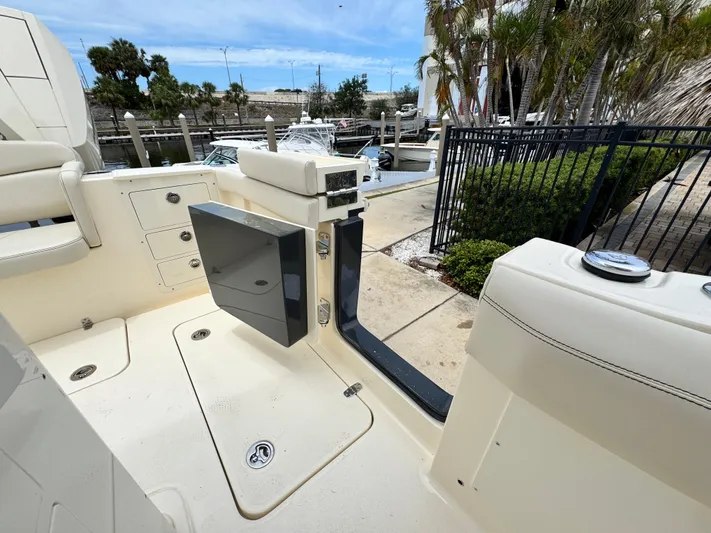  Yacht Photos Pics 2025 Scout 305 LXF boat interior, featuring open deck and marina view.
