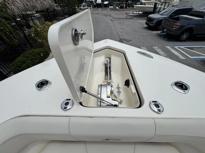  Yacht Photos Pics 2025 Scout 305 LXF boat anchor compartment open, showcasing storage and design features.