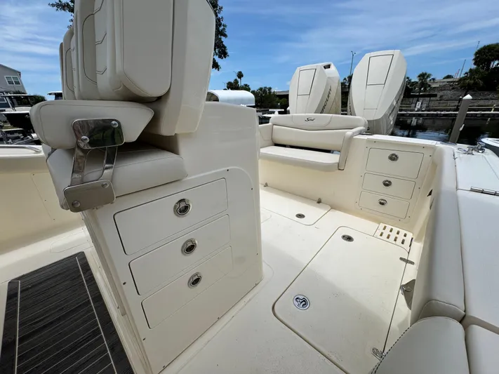  Yacht Photos Pics 2025 Scout 305 LXF boat interior with seating and storage compartments.