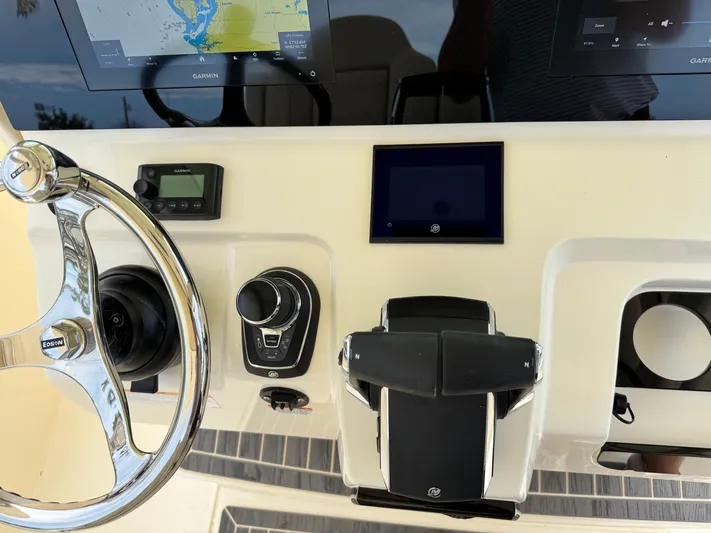  Yacht Photos Pics 2025 Scout 305 LXF boat dashboard with steering wheel and navigation controls.