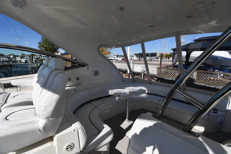  Yacht Photos Pics 2005 Cruisers Yachts 500 Express interior with white seating and marina view.