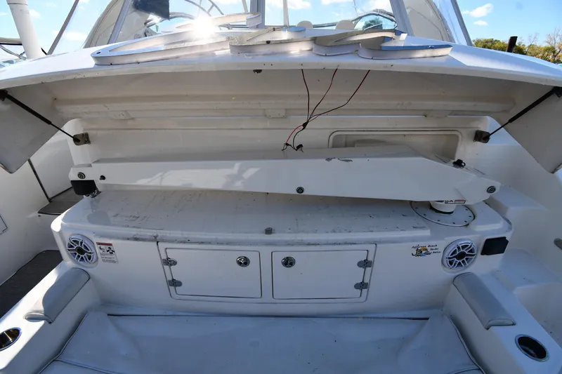  Yacht Photos Pics 2005 Cruisers Yachts 500 Express interior with open storage compartment and speakers.