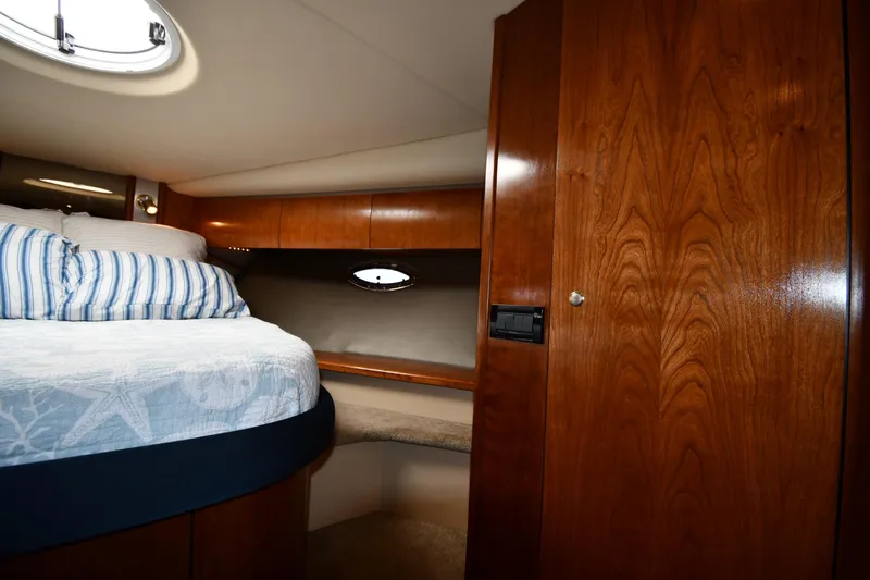  Yacht Photos Pics 2005 Cruisers Yachts 500 Express cabin with wood paneling and cozy bed.