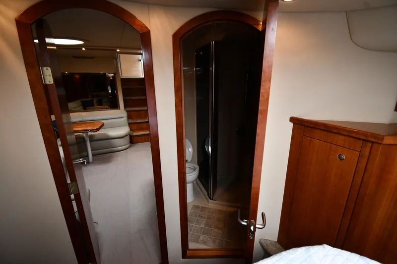  Yacht Photos Pics Interior of 2005 Cruisers Yachts 500 Express, featuring wood cabinetry and cozy seating area.