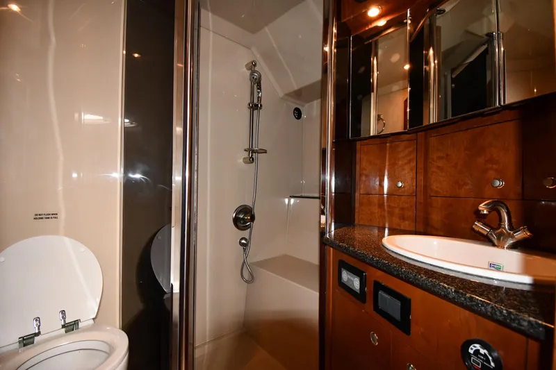  Yacht Photos Pics Luxurious bathroom in 2005 Cruisers Yachts 500 Express with shower, sink, and toilet.