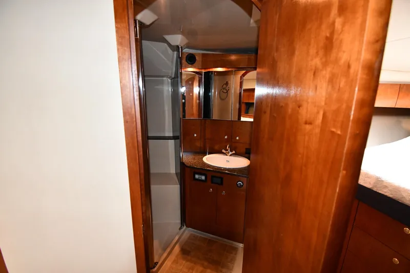  Yacht Photos Pics 2005 Cruisers Yachts 500 Express bathroom with wooden cabinetry and modern fixtures.