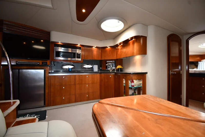  Yacht Photos Pics Luxurious 2005 Cruisers Yachts 500 Express interior with modern kitchen and elegant wood finishes.