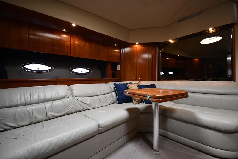  Yacht Photos Pics Luxurious 2005 Cruisers Yachts 500 Express interior with leather seating and wooden table.