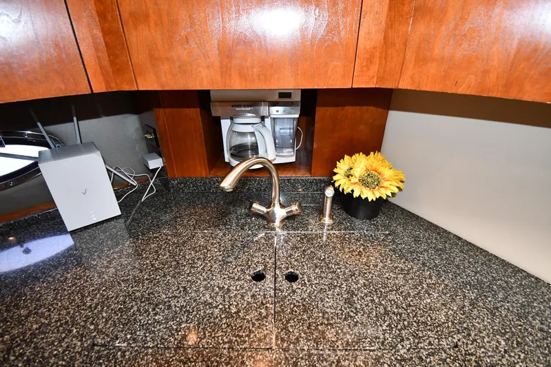  Yacht Photos Pics Luxury yacht kitchen with granite countertop, coffee maker, and sunflowers. Cruisers Yachts 500 Express 2005.