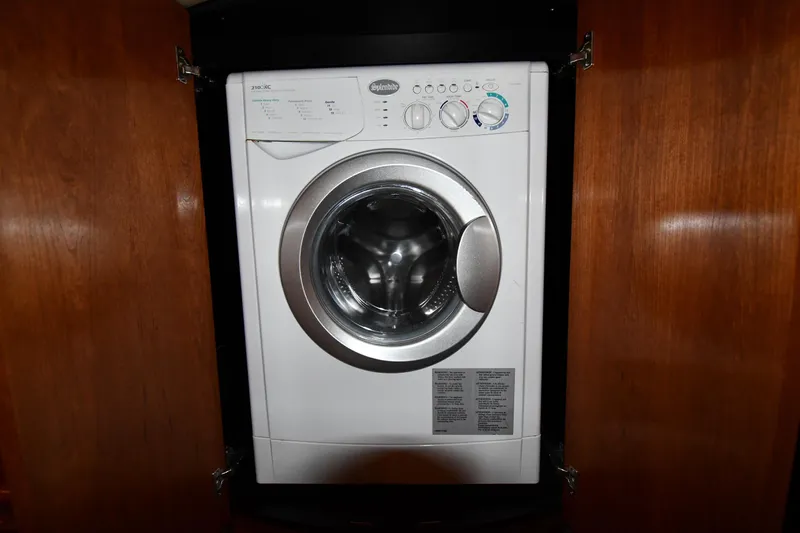  Yacht Photos Pics Washing machine inside 2005 Cruisers Yachts 500 Express, wooden cabinet doors open.