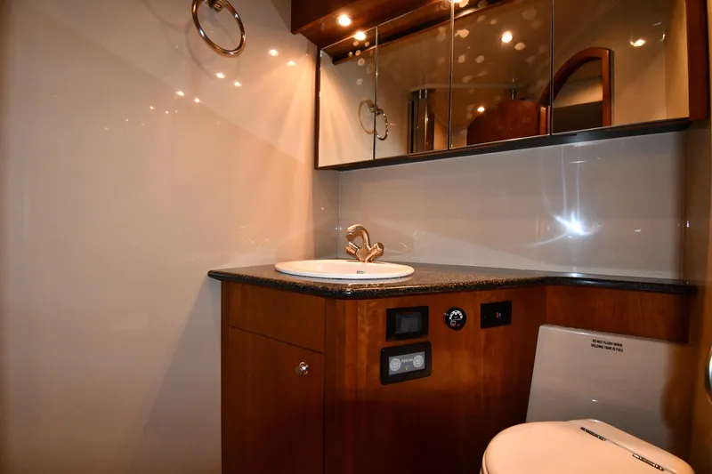  Yacht Photos Pics Luxurious bathroom interior of 2005 Cruisers Yachts 500 Express with modern fixtures.