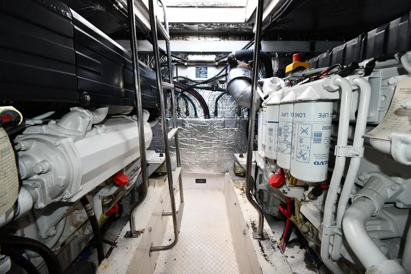  Yacht Photos Pics Engine room of 2005 Cruisers Yachts 500 Express, showcasing dual engines and mechanical components.