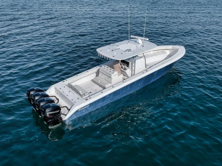  Yacht Photos Pics Aerial view of 2013 Bahama 41 boat with triple outboard motors on open water.