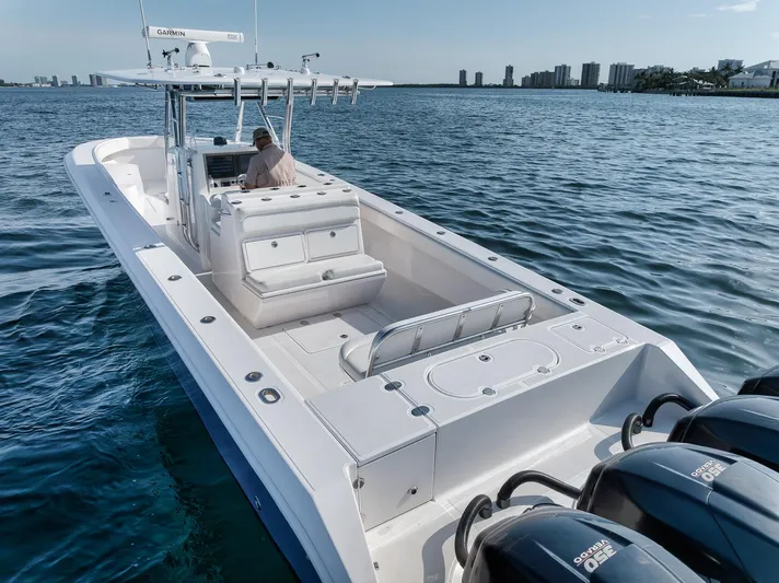  Yacht Photos Pics 2013 Bahama 41 boat on water, featuring spacious deck and multiple outboard engines.