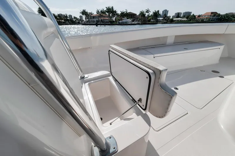  Yacht Photos Pics 2013 Bahama 41 boat deck with open storage compartment, overlooking waterfront homes and palm trees.
