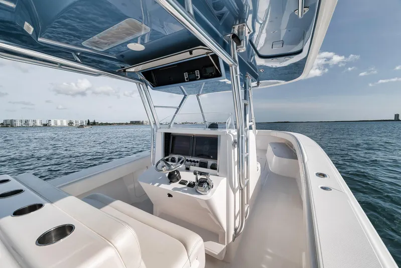  Yacht Photos Pics 2013 Bahama 41 boat cockpit with steering wheel, navigation screens, and ocean view.
