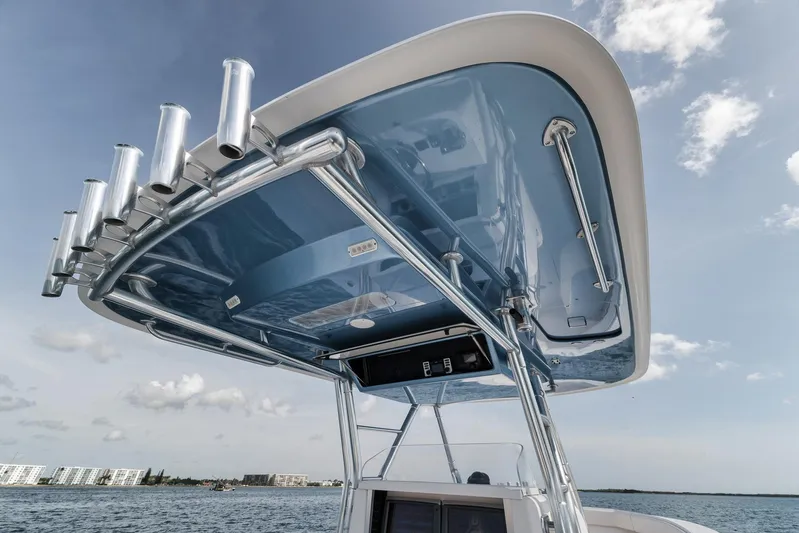  Yacht Photos Pics T-top of 2013 Bahama 41 boat with rod holders, under a clear sky.