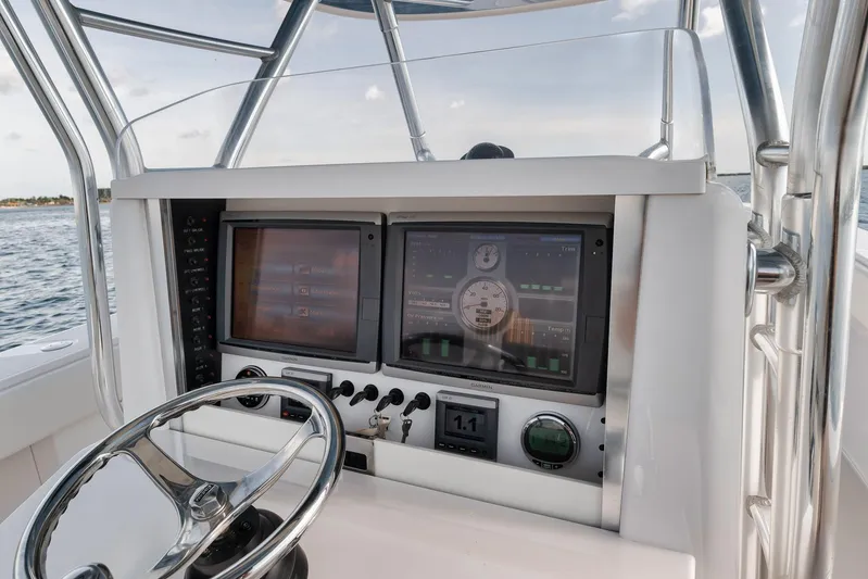  Yacht Photos Pics Control panel of a 2013 Bahama 41 boat with dual displays and steering wheel.