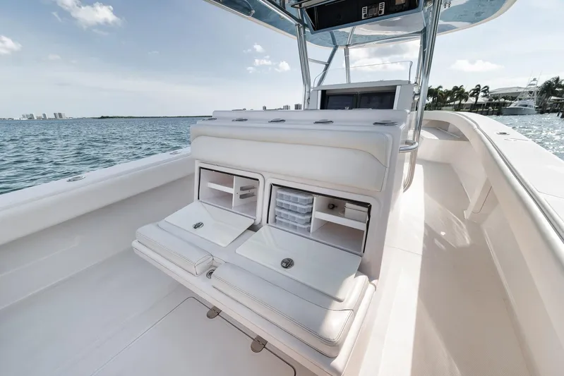  Yacht Photos Pics 2013 Bahama 41 boat interior with seating and storage, on calm water.