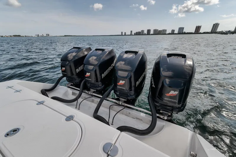 Yacht Photos Pics Four Mercury outboard engines on a 2013 Bahama 41 boat, ocean and city skyline in background.