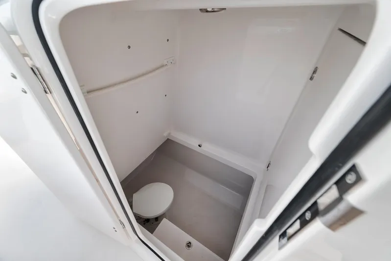  Yacht Photos Pics Compact bathroom in 2013 Bahama 41 boat, featuring a toilet and white interior.
