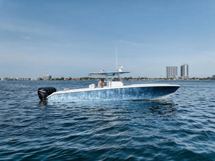  Yacht Photos Pics 2013 Bahama 41 boat on calm water with city skyline in background.