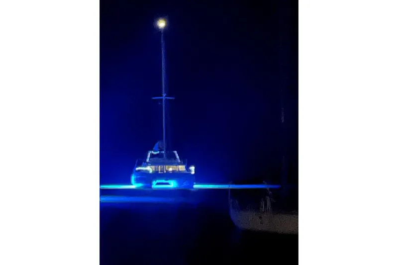 Morgan Blu Yacht Photos Pics Bali 5.4 catamaran illuminated with blue lights at night, 2021 model.