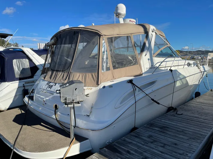  Yacht Photos Pics 2000 Sea Ray 380 Sundancer docked, featuring beige canopy and sleek white design.
