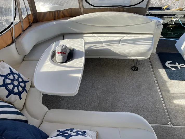  Yacht Photos Pics Interior of 2000 Sea Ray 380 Sundancer with white seating and nautical decor.