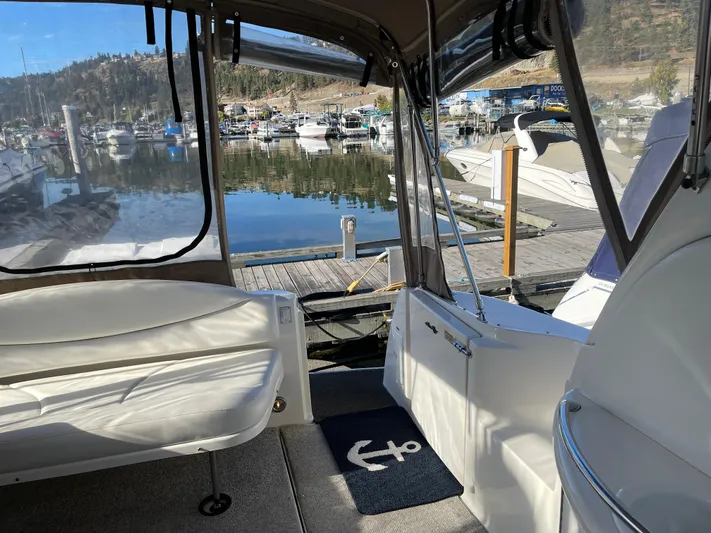 Yacht Photos Pics Interior view of 2000 Sea Ray 380 Sundancer at marina, featuring seating and dockside scenery.