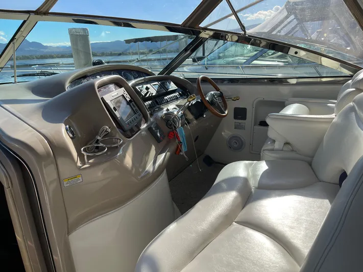  Yacht Photos Pics Interior view of 2000 Sea Ray 380 Sundancer boat cockpit with leather seating and control panel.