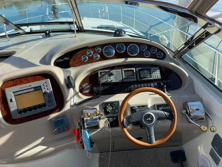  Yacht Photos Pics Cockpit of 2000 Sea Ray 380 Sundancer with steering wheel and navigation instruments.