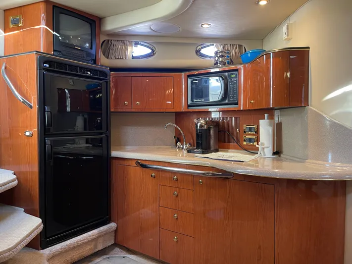  Yacht Photos Pics Luxurious kitchen interior of 2000 Sea Ray 380 Sundancer yacht with modern amenities.