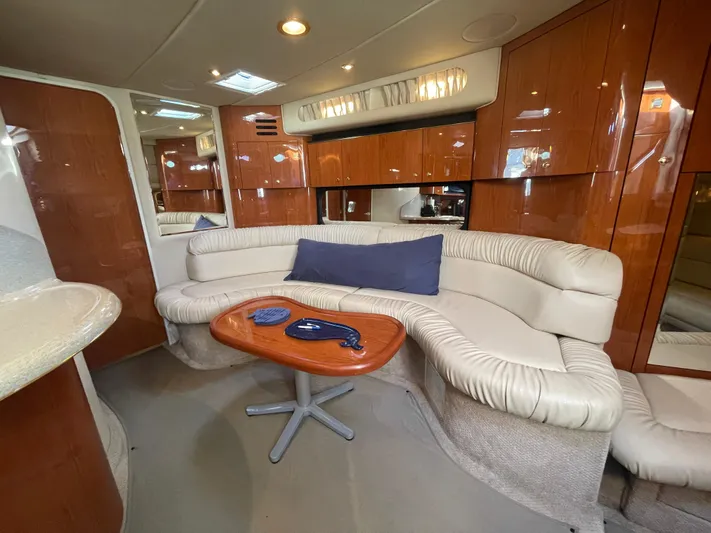  Yacht Photos Pics Luxurious interior of 2000 Sea Ray 380 Sundancer with plush seating and wooden accents.