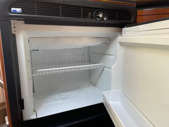  Yacht Photos Pics Open refrigerator inside 2000 Sea Ray 380 Sundancer yacht, showing empty shelves.