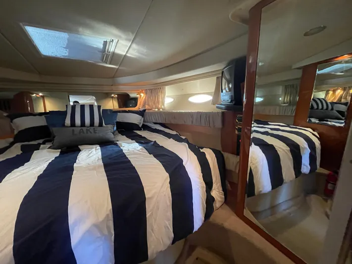  Yacht Photos Pics Interior of 2000 Sea Ray 380 Sundancer with striped bedding and mirrored closet.