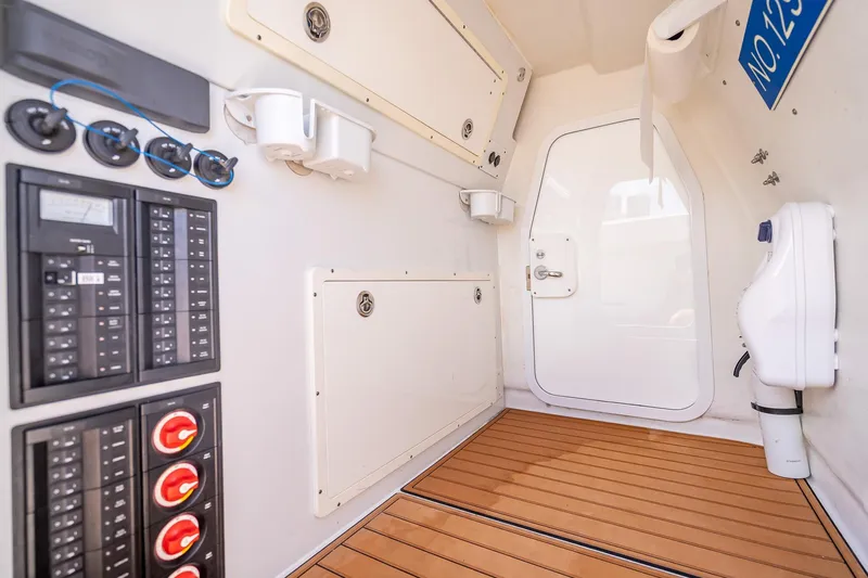  Yacht Photos Pics Interior of 2019 Freeman 42LR boat with control panels and wooden flooring.
