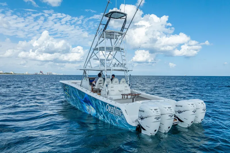  Yacht Photos Pics 2019 Freeman 42LR boat with four engines cruising on open ocean under blue sky.