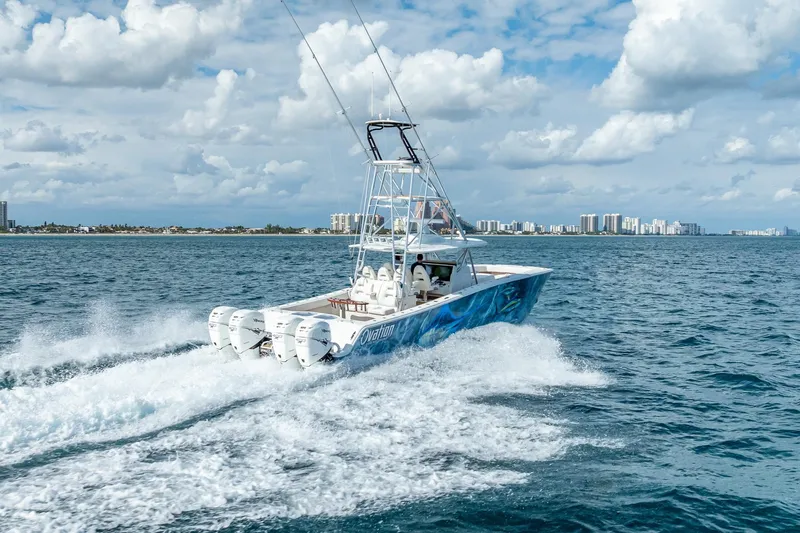  Yacht Photos Pics 2019 Freeman 42LR boat cruising on ocean with city skyline in background.