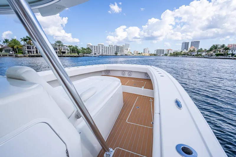  Yacht Photos Pics 2019 Freeman 42LR boat cruising near waterfront cityscape under blue sky.