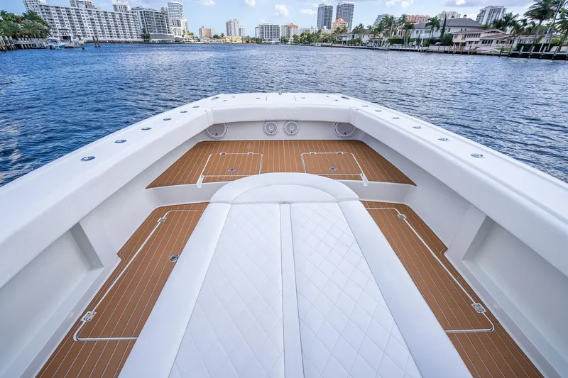  Yacht Photos Pics 2019 Freeman 42LR boat deck with luxurious seating, overlooking a scenic waterfront cityscape.