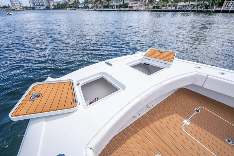  Yacht Photos Pics 2019 Freeman 42LR boat deck with open storage compartments on calm water.