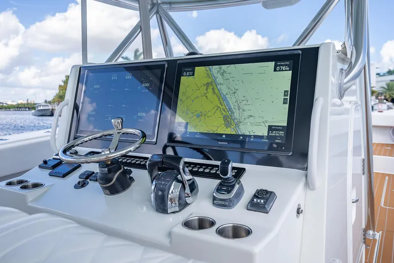  Yacht Photos Pics Control panel of 2019 Freeman 42LR boat with navigation screens and steering wheel.