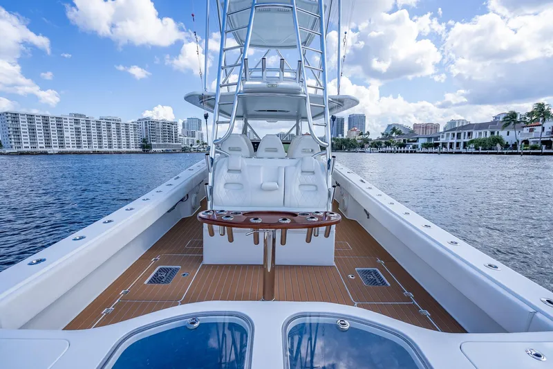  Yacht Photos Pics 2019 Freeman 42LR boat on water, cityscape background, clear sky.